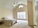 Bright bedroom with vaulted ceilings, carpet, ceiling fan, and large windows at 636 Lantern Park Ln, Scottdale, GA 30079