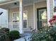 Inviting front porch and flower garden creating an appealing entrance at 636 Lantern Park Ln, Scottdale, GA 30079