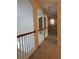Upstairs hallway with natural light and decorative chandelier at 636 Lantern Park Ln, Scottdale, GA 30079