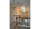 Upstairs hallway with natural light, chandelier, and railing at 636 Lantern Park Ln, Scottdale, GA 30079
