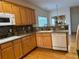 Modern kitchen features stainless appliances, wood cabinets and hardwood floors at 636 Lantern Park Ln, Scottdale, GA 30079