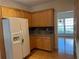 Well-lit kitchen featuring wood cabinets, backsplash, and stainless-steel refrigerator at 636 Lantern Park Ln, Scottdale, GA 30079