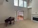 View of the living room with fireplace, high ceilings and piano at 636 Lantern Park Ln, Scottdale, GA 30079