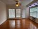Bright living room with hardwood floors, a ceiling fan, and large windows for lots of light at 636 Lantern Park Ln, Scottdale, GA 30079