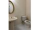 Traditional powder room featuring pedestal sink, crystal faucet handles, and white toilet at 636 Lantern Park Ln, Scottdale, GA 30079