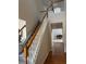 Carpeted staircase with lift and wood railing at 636 Lantern Park Ln, Scottdale, GA 30079