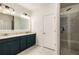 Spacious bathroom featuring double sinks, modern lighting, and a glass-enclosed shower at 1661 Hammock Dr, Smyrna, GA 30080