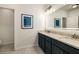 Bathroom with double sink vanity, a framed mirror and tiled floors at 1661 Hammock Dr, Smyrna, GA 30080