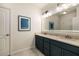 Bathroom featuring double sinks, framed mirror and tiled floors at 1661 Hammock Dr, Smyrna, GA 30080