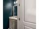A modern half-bathroom with a granite countertop and a stylish mirror at 1661 Hammock Dr, Smyrna, GA 30080