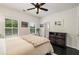 A comfortable bedroom with a ceiling fan, shuttered windows, and modern decor at 1661 Hammock Dr, Smyrna, GA 30080