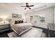 Bright bedroom with tray ceilings, ceiling fan, and a large window at 1661 Hammock Dr, Smyrna, GA 30080