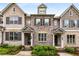 Beautiful townhome with gray brick, shuttered windows and landscaped flower beds at 1661 Hammock Dr, Smyrna, GA 30080