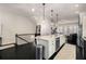 Bright kitchen with a center island, stainless appliances, and dark hardwood floors at 1661 Hammock Dr, Smyrna, GA 30080