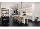 Open kitchen with an island with pendant lights, stainless appliances, and hardwood floors at 1661 Hammock Dr, Smyrna, GA 30080