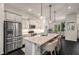 Bright kitchen with a center island, stainless appliances, and dark hardwood floors at 1661 Hammock Dr, Smyrna, GA 30080