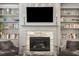 Close-up of a fireplace with stone surround, built-in bookshelves, and stylish decor at 1661 Hammock Dr, Smyrna, GA 30080