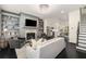 An open living room with a fireplace, built-in bookshelves, and stairs to the upper level at 1661 Hammock Dr, Smyrna, GA 30080