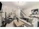 An open living room with a fireplace, built-in bookshelves, and views into the kitchen at 1661 Hammock Dr, Smyrna, GA 30080