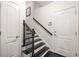 Stairwell has dark-stained hardwood steps, decorative metal railings, and natural wood handrail at 1661 Hammock Dr, Smyrna, GA 30080