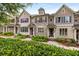 Townhome exteriors featuring brick and siding, complemented by lush greenery and landscaped walkways at 1661 Hammock Dr, Smyrna, GA 30080