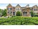 Street view of upscale townhomes with brick facade and manicured landscaping at Brandly Hall at 1661 Hammock Dr, Smyrna, GA 30080