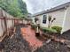 Landscaped backyard with brick pathway at 1822 Commonwealth Dr, Woodstock, GA 30188