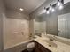 Bathroom with updated fixtures, shower-tub combination, and bright vanity at 1822 Commonwealth Dr, Woodstock, GA 30188