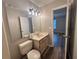 Neutrally painted bathroom with vanity sink, modern fixtures, and vinyl flooring at 1822 Commonwealth Dr, Woodstock, GA 30188