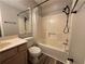 Bright bathroom features a shower-tub combination with modern fixtures and neutral decor at 1822 Commonwealth Dr, Woodstock, GA 30188