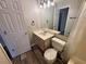 Neutral bathroom with vanity sink, modern fixtures, and wood-look vinyl flooring at 1822 Commonwealth Dr, Woodstock, GA 30188
