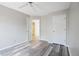 Bedroom with light gray walls, new floor, ceiling fan, and closet at 1822 Commonwealth Dr, Woodstock, GA 30188