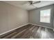 Neutral bedroom with ceiling fan, natural light, and wood-look vinyl flooring at 1822 Commonwealth Dr, Woodstock, GA 30188