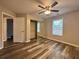 Bedroom with ceiling fan, natural light, closet, and wood-look vinyl flooring at 1822 Commonwealth Dr, Woodstock, GA 30188