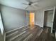 Cozy bedroom with a ceiling fan, wood-look floors, and two closets at 1822 Commonwealth Dr, Woodstock, GA 30188