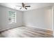 Bedroom with light gray walls, new floor, ceiling fan, and window at 1822 Commonwealth Dr, Woodstock, GA 30188