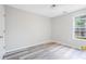 Bedroom with light gray walls, new floor, ceiling fan, and window at 1822 Commonwealth Dr, Woodstock, GA 30188