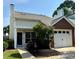 Charming home featuring mixed siding, attached garage, manicured landscaping, and a welcoming front entry at 1822 Commonwealth Dr, Woodstock, GA 30188