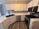 Well-lit kitchen with stainless steel appliances, white cabinets, and stylish countertops at 1822 Commonwealth Dr, Woodstock, GA 30188