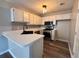 Modern kitchen with white cabinets, stainless steel appliances, and sleek countertops at 1822 Commonwealth Dr, Woodstock, GA 30188