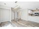 Bright open floor plan with spiral staircase, wood floors and white kitchen cabinets at 1822 Commonwealth Dr, Woodstock, GA 30188