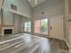 Spacious living room with wood-look flooring, fireplace, and natural light at 1822 Commonwealth Dr, Woodstock, GA 30188