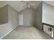 Spacious loft featuring vaulted ceilings, neutral paint, and a ceiling fan at 1822 Commonwealth Dr, Woodstock, GA 30188
