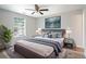 Main bedroom with new floor, king bed, lights, and window at 1822 Commonwealth Dr, Woodstock, GA 30188