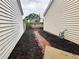 Side yard with brick pathway and mulch at 1822 Commonwealth Dr, Woodstock, GA 30188