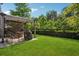 Lush backyard featuring a covered patio area and ample green space, perfect for outdoor enjoyment at 2127 Apple Orchard Way, Austell, GA 30168