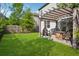 A well maintained backyard offers a pergola-covered patio space and ample lawn for recreation at 2127 Apple Orchard Way, Austell, GA 30168