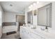 Bathroom features double sinks with modern faucets, framed mirrors, tiled floors, and separate tub and shower at 2127 Apple Orchard Way, Austell, GA 30168