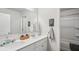 Bathroom featuring double sinks, white cabinets, and a large mirror, all in a bright setting at 2127 Apple Orchard Way, Austell, GA 30168