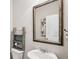 Cozy half-bath features stylish decor, a quaint sink, and a decorative shelf above the toilet at 2127 Apple Orchard Way, Austell, GA 30168